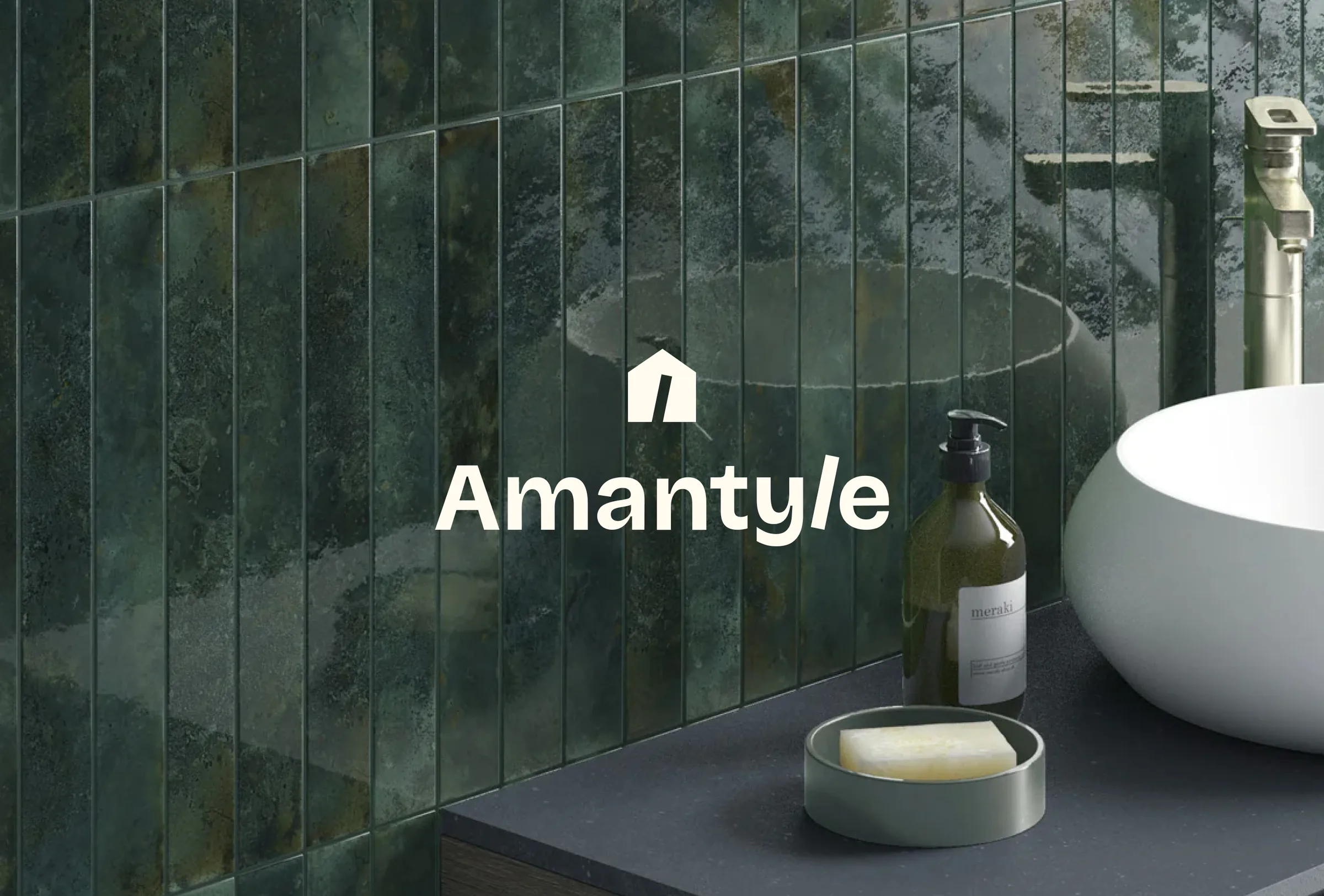 The hero: the Amantyle house mark and wordmark in cream over a wall of green vertical tiles beside a basin.